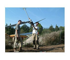 Workers install a wind turbine